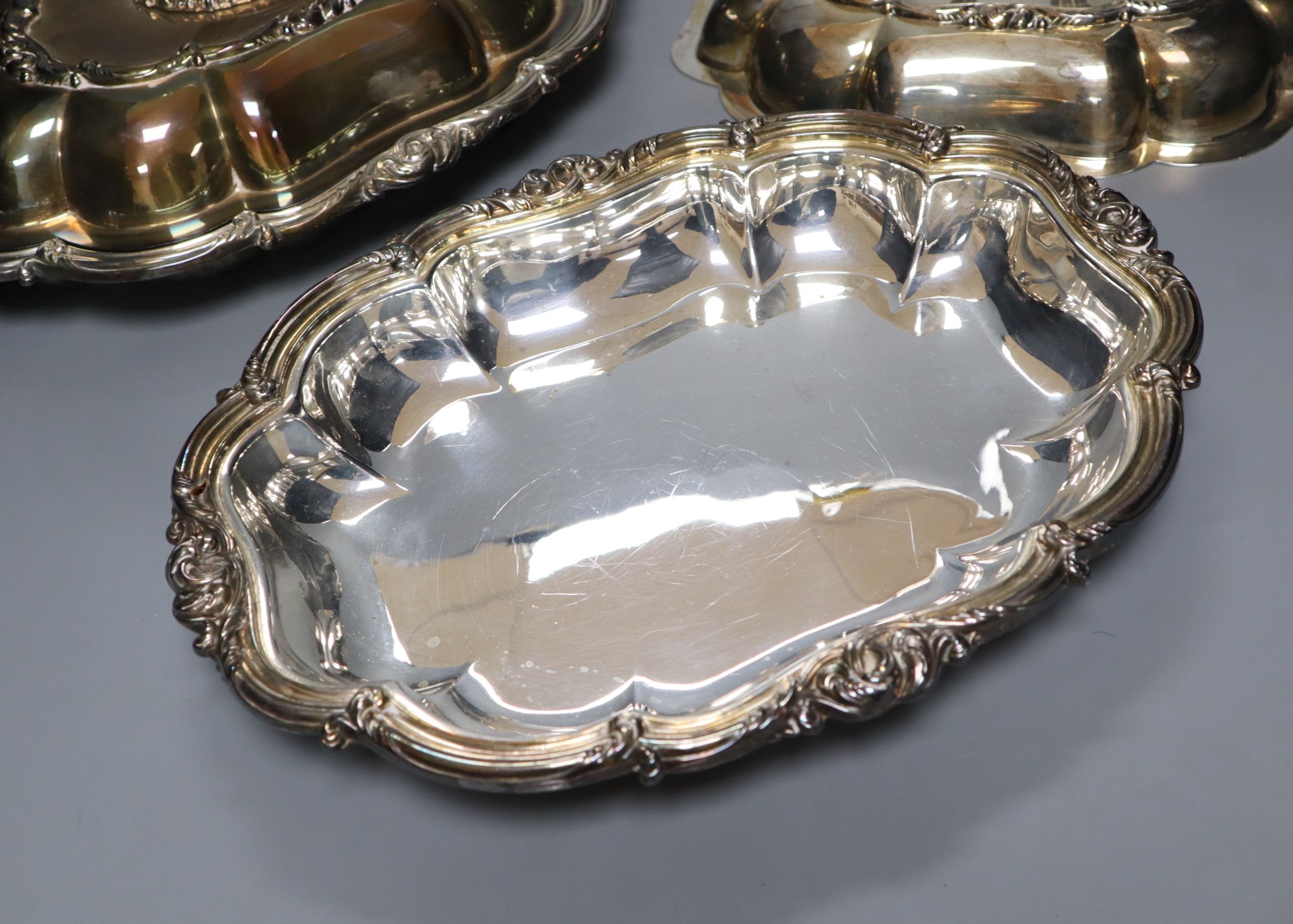 A pair of Victorian plated tureens and a plater sugar sifter
